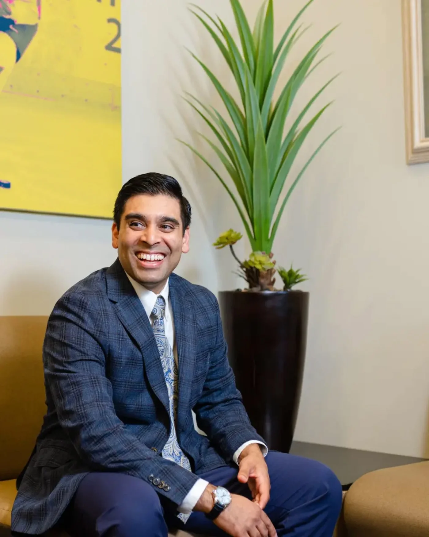 Dr. Vivek Babaria, DO, seated at DISC Sports and Spine Center in Newport Beach