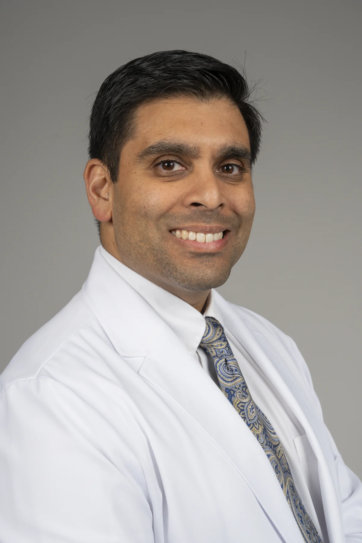 Dr. Vivek Babaria, DO, in a white coat, Carpe Diem Medical Newport Beach